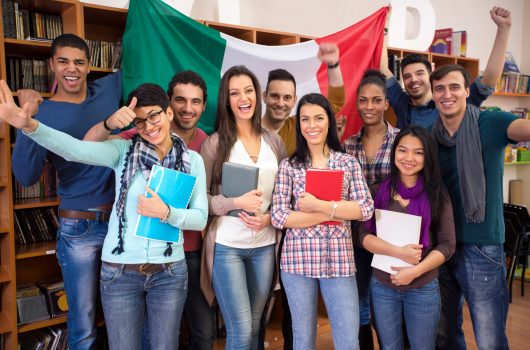 Multiethnic  cheerful students present Italy with flag